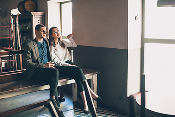 Image showing Cheerful man and woman talking, enjoying, having fun at bar, cafe