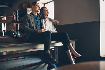 Image showing Cheerful man and woman talking, enjoying, having fun at bar, cafe