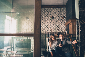 Image showing Cheerful man and woman talking, enjoying, having fun at bar, cafe