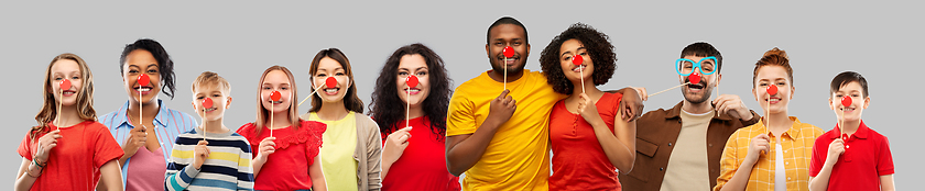 Image showing group of happy smiling people with red clown noses