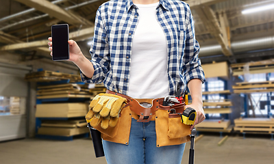 Image showing female worker with phone and tools at factory