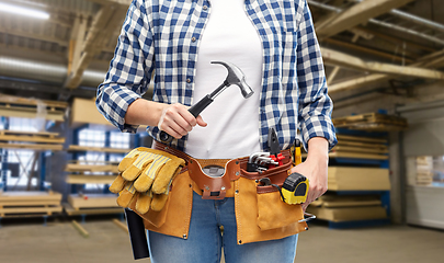 Image showing female worker with hammer and tools on belt