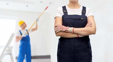 Image showing close up of female painter or builder in overall