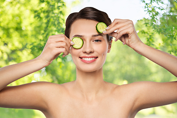 Image showing beautiful woman making eye mask of cucumbers