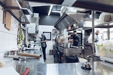 Image showing Behind the scenes of brands. The chef cooking in a professional kitchen of a restaurant meal for client or delivery. Motion.