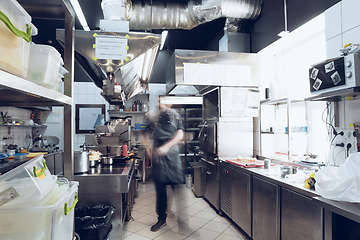 Image showing Behind the scenes of brands. The chef cooking in a professional kitchen of a restaurant meal for client or delivery. Motion.