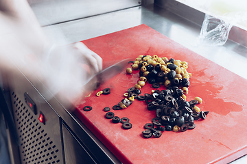 Image showing Behind the scenes of brands. The chef cooking in a professional kitchen of a restaurant meal for client or delivery. Motion.