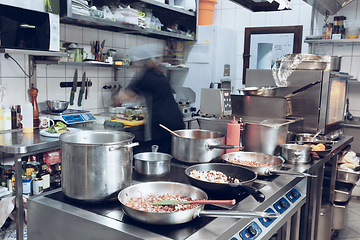 Image showing Behind the scenes of brands. The chef cooking in a professional kitchen of a restaurant meal for client or delivery. Motion.