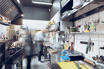 Image showing Behind the scenes of brands. The chef cooking in a professional kitchen of a restaurant meal for client or delivery. Motion.