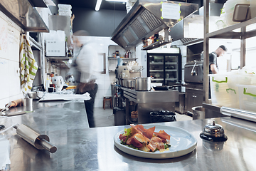 Image showing Behind the scenes of brands. The chef cooking in a professional kitchen of a restaurant meal for client or delivery. Motion.