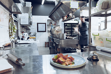 Image showing Behind the scenes of brands. The chef cooking in a professional kitchen of a restaurant meal for client or delivery. Motion.