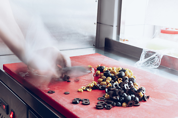 Image showing Behind the scenes of brands. The chef cooking in a professional kitchen of a restaurant meal for client or delivery. Motion.