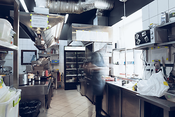 Image showing Behind the scenes of brands. The chef cooking in a professional kitchen of a restaurant meal for client or delivery. Motion.