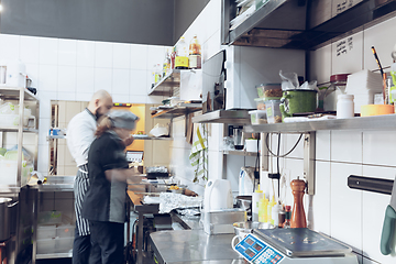 Image showing Behind the scenes of brands. The chef cooking in a professional kitchen of a restaurant meal for client or delivery. Motion.