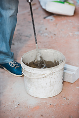 Image showing Close up of hand of repairman, professional builder working indoors, repairing