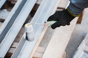 Image showing Close up of hand of repairman, professional builder working indoors, repairing