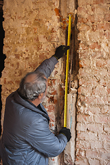 Image showing Repairman, professional builder working indoors, repairing