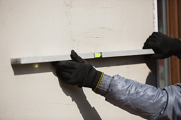 Image showing Close up of hand of repairman, professional builder working indoors, repairing