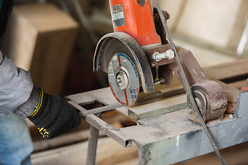 Image showing Close up of hand of repairman, professional builder working indoors, repairing