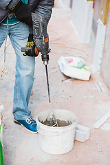 Image showing Close up of hand of repairman, professional builder working indoors, repairing