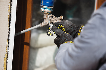 Image showing Close up of hand of repairman, professional builder working indoors, repairing