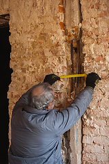 Image showing Repairman, professional builder working indoors, repairing