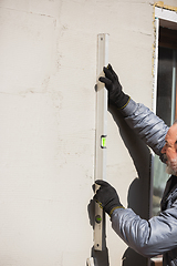 Image showing Close up of hand of repairman, professional builder working indoors, repairing