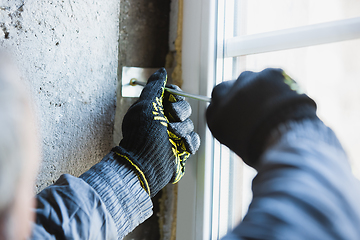 Image showing Close up of hand of repairman, professional builder working indoors, repairing