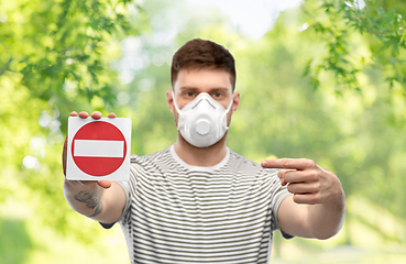 Image showing man in respirator mask showing stop sign