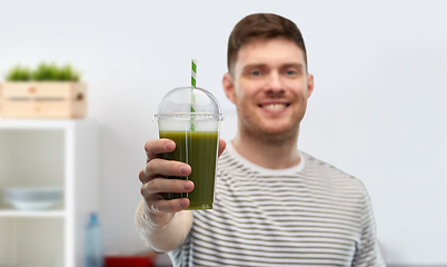 Image showing man drinking green smoothie from disposable cup