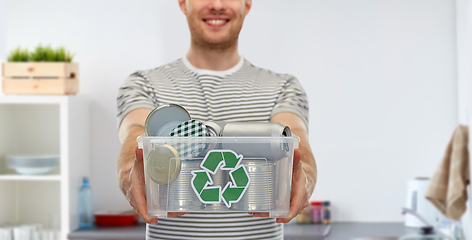 Image showing smiling young man sorting metallic waste