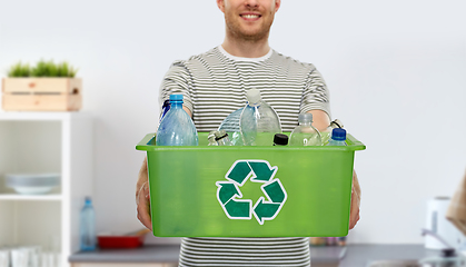 Image showing smiling young man sorting plastic waste