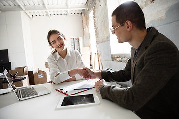 Image showing Female estate agent showing new home to a young man after a discussion on house plans, moving, new home concept