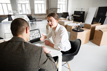 Image showing Female estate agent showing new home to a young man after a discussion on house plans, moving, new home concept