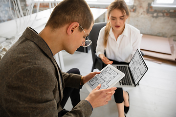 Image showing Female estate agent showing new home to a young man after a discussion on house plans, moving, new home concept