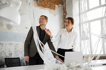 Image showing Female estate agent showing new home to a young man after a discussion on house plans, moving, new home concept