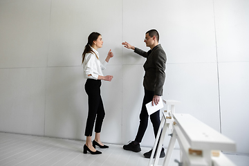 Image showing Female estate agent showing new home to a young man after a discussion on house plans, moving, new home concept