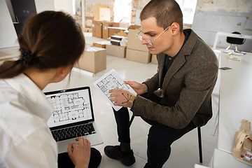 Image showing Female estate agent showing new home to a young man after a discussion on house plans, moving, new home concept