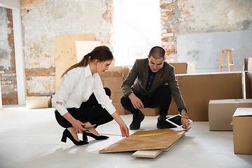 Image showing Female estate agent showing new home to a young man after a discussion on house plans, moving, new home concept