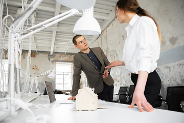 Image showing Female estate agent showing new home to a young man after a discussion on house plans, moving, new home concept