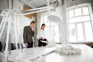 Image showing Female estate agent showing new home to a young man after a discussion on house plans, moving, new home concept