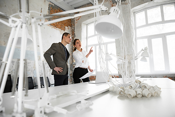 Image showing Female estate agent showing new home to a young man after a discussion on house plans, moving, new home concept