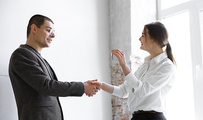 Image showing Female estate agent showing new home to a young man after a discussion on house plans, moving, new home concept