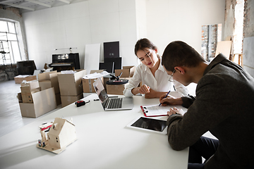 Image showing Female estate agent showing new home to a young man after a discussion on house plans, moving, new home concept