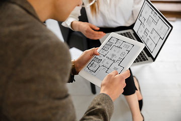 Image showing Female estate agent showing new home to a young man after a discussion on house plans, moving, new home concept