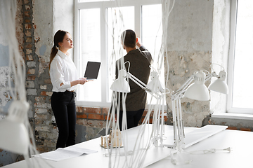 Image showing Female estate agent showing new home to a young man after a discussion on house plans, moving, new home concept