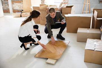 Image showing Female estate agent showing new home to a young man after a discussion on house plans, moving, new home concept