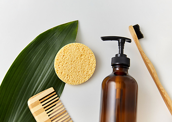 Image showing comb, sponge, liquid soap or shower gel and leaf