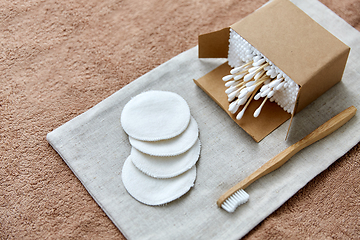 Image showing wooden toothbrush, cotton pads and swabs in box