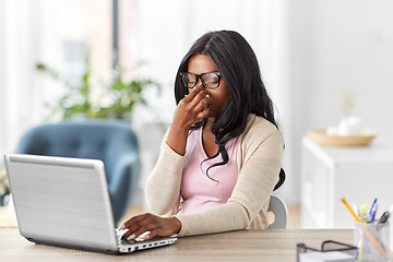 Image showing tired woman with laptop working at home office